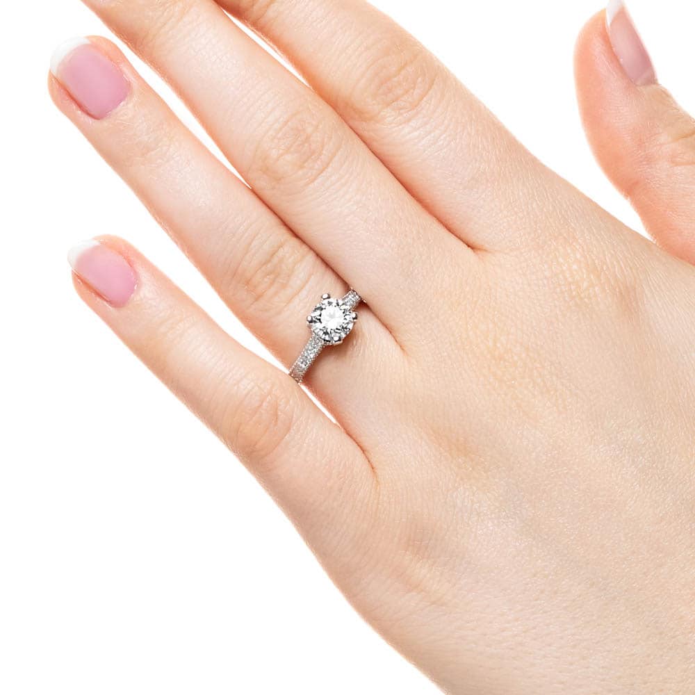 Shown with 1ct Round Cut Lab Grown Diamond in 14k White Gold|Antique style diamond accented engagement ring with 1ct round cut lab grown diamond in 14k white gold filigree detailed band worn on hand