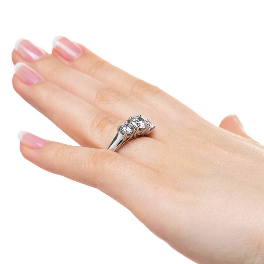 Shown with Three Round Cut Lab Grown Diamonds in 14k White Gold|Three stone engagement ring with round cut lab grown diamonds in 14k white gold worn on hand sideview