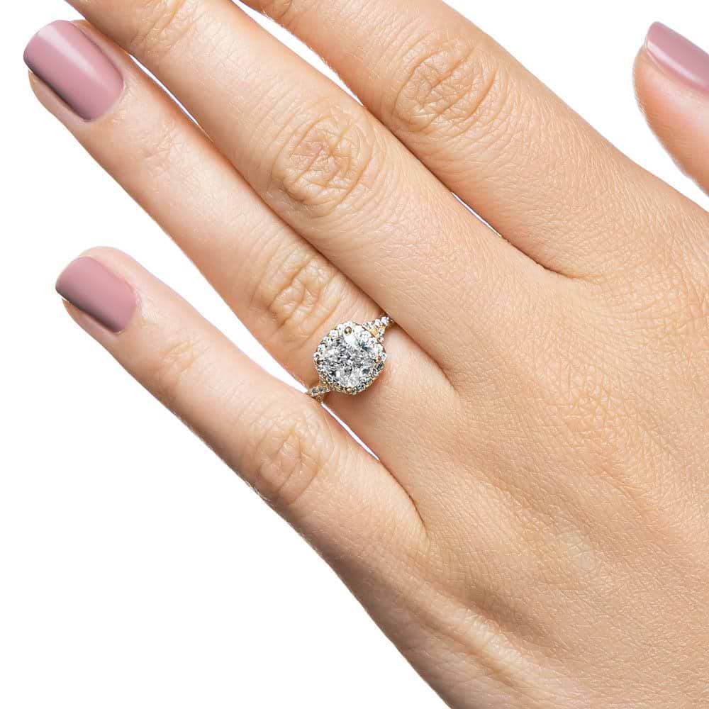 Shown with 1ct Cushion Cut Lab Grown Diamond in 14k Yellow Gold|Diamond halo engagement ring with crossover split shank band set with 1ct cushion cut lab grown diamond in 14k yellow gold shown worn on hand