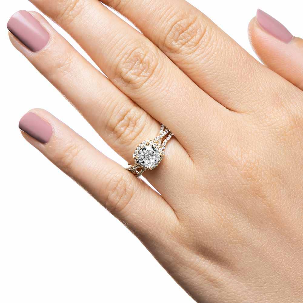 Eternal Monogram Wedding Set shown in recycled 14K yellow gold featuring a cushion cut center stone surrounded by a halo of recycled diamonds continuing down the shank with matching wedding band | eternal monogram wedding set recycled diamonds engagement ring wedding band
