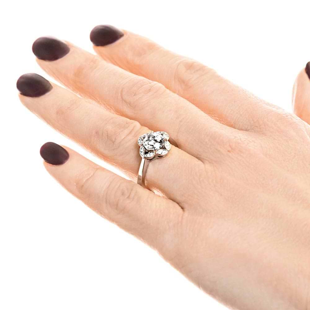 Shown with 1ct round cut lab grown diamond in 14k white gold|Nature inspired vintage style engagement ring with floral petal halo design around a 1ct round cut lab diamond in 14k white gold