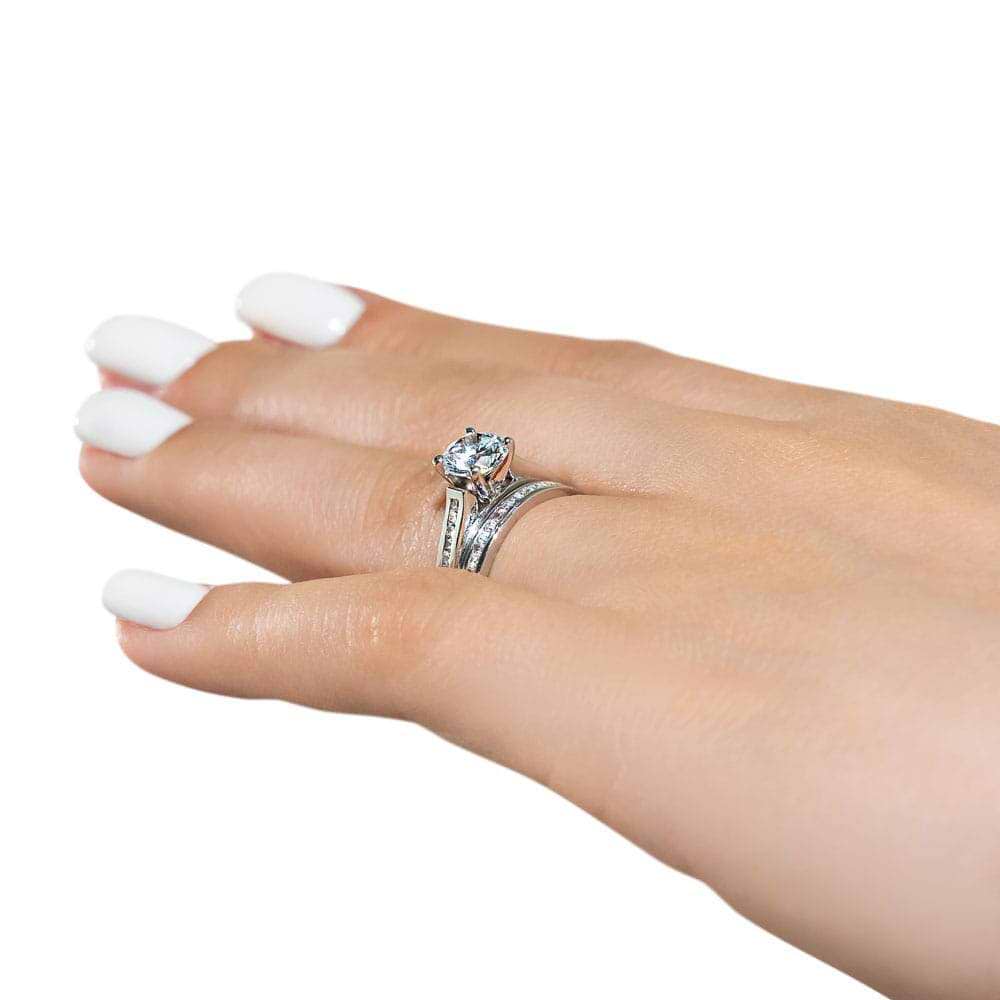 Shown with a 1.0ct Round cut Lab Grown Diamond with channel set diamond accented band with matching wedding band in recycled 14K white gold | wedding set Shown with a 1.0ct Round cut Lab Grown Diamond with channel set diamond accented band with matching wedding band in recycled 14K white gold