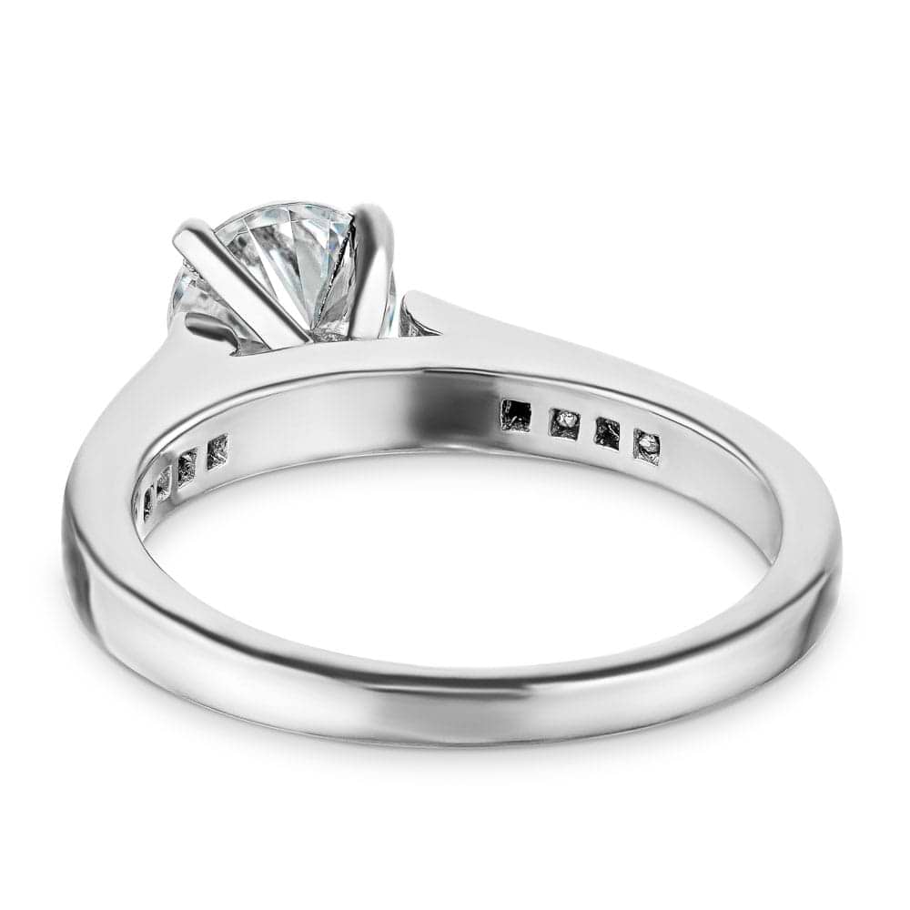 Shown with a 1.0ct Round cut Lab Grown Diamond with channel set diamond accented band in recycled 14K white gold 