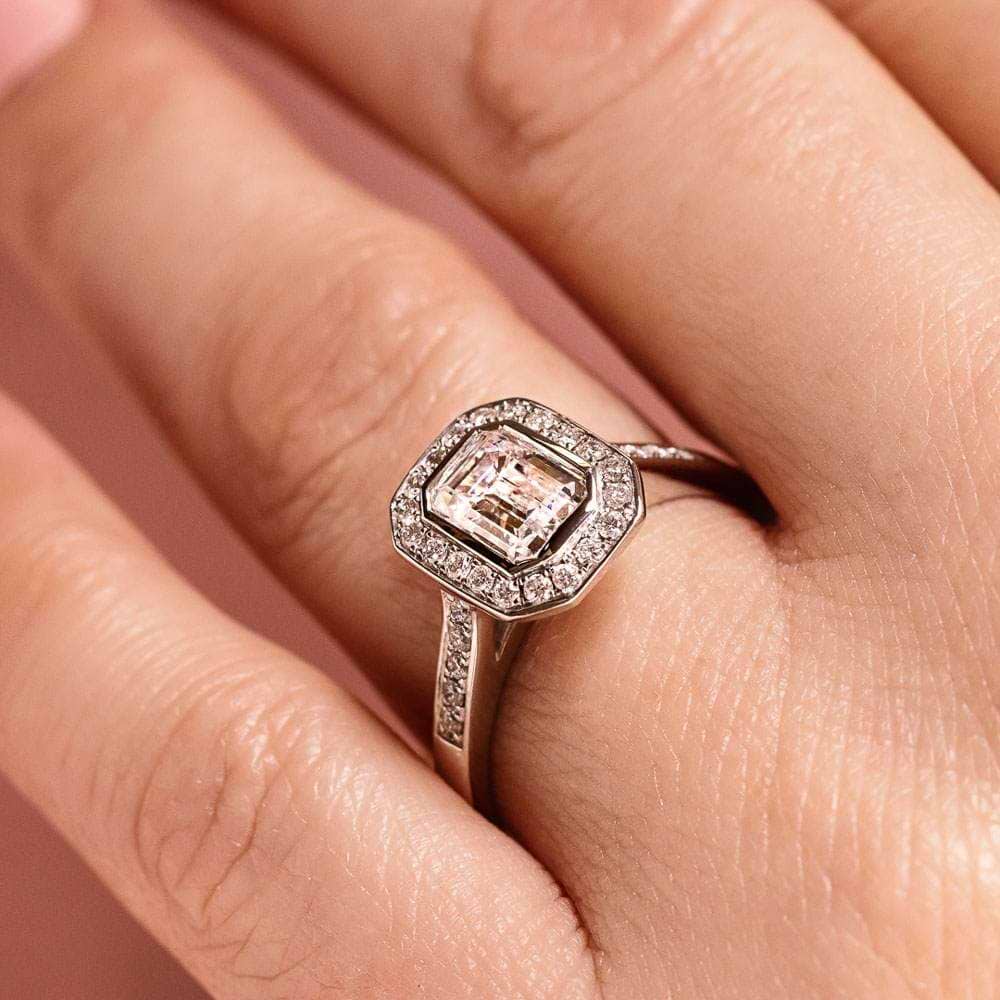 Shown with 1ct Emerald Cut Lab Grown Diamond in 14k White Gold|Beautiful vintage style diamond accented halo engagement ring with 1ct emerald cut lab grown diamond in 14k white gold worn on hand