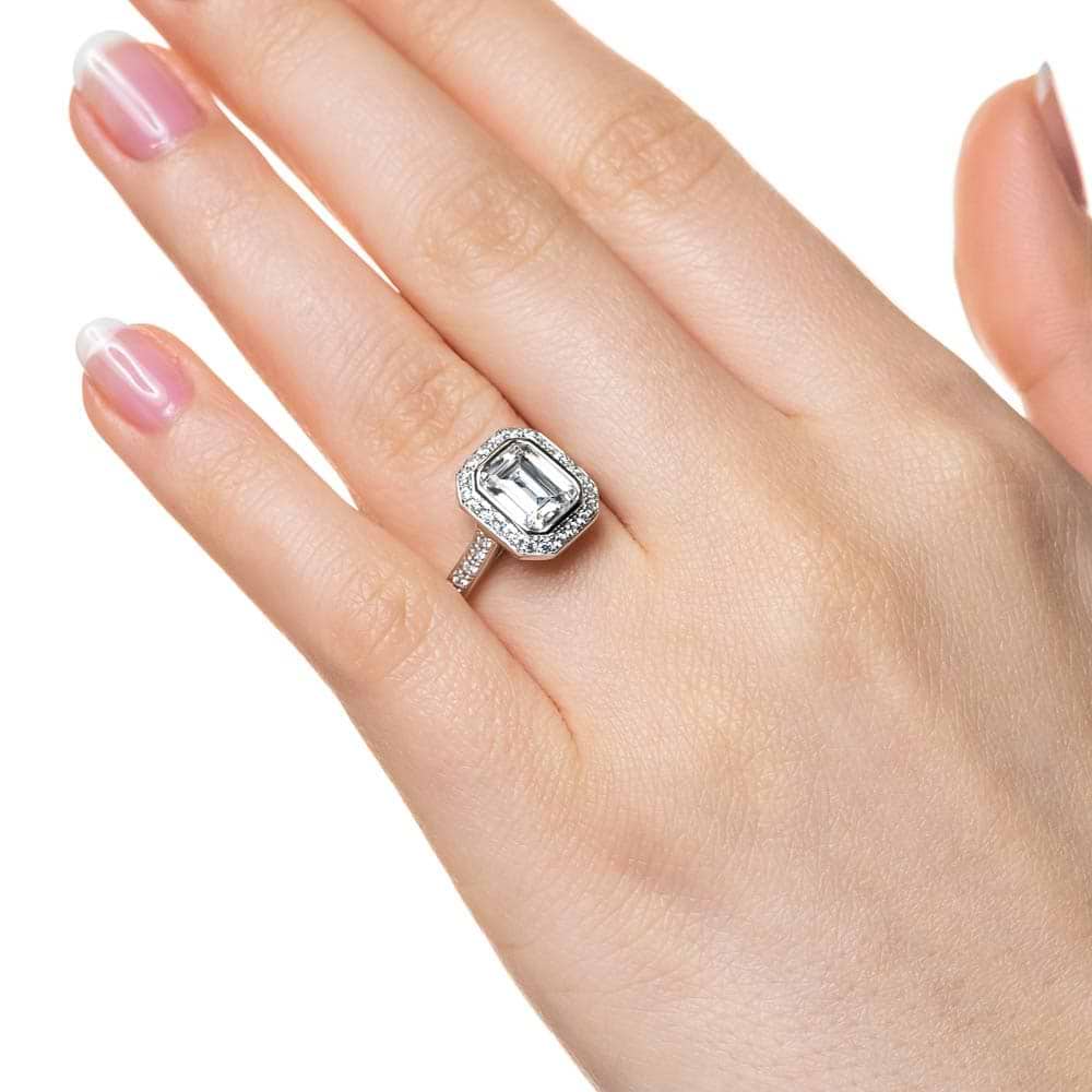 Shown with 1ct Emerald Cut Lab Grown Diamond in 14k White Gold|Vintage style diamond accented halo engagement ring with 1ct emerald cut lab grown diamond in 14k white gold worn on hand