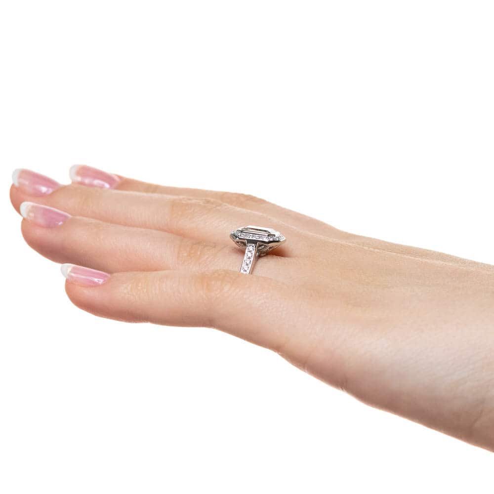 Shown with 1ct Emerald Cut Lab Grown Diamond in 14k White Gold|Vintage style diamond accented halo engagement ring with 1ct emerald cut lab grown diamond in 14k white gold worn on hand sideview