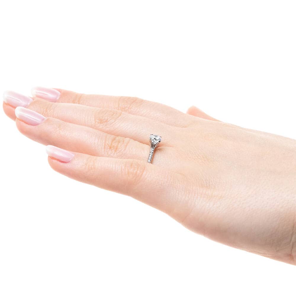 Shown with 0.70ct Round Cut Lab Grown Diamond in 14k White Gold|Diamond accented solitaire engagement ring with 4 prong set round cut lab grown diamond in 14k white gold worn on hand sideview