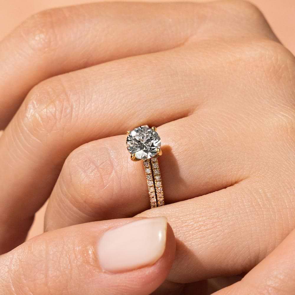 Shown with a 2.0ct Round cut Lab-Grown Diamond with a diamond accented band in recycled 14K yellow gold with matching wedding band | wedding set Shown with a 1.0ct Round cut Lab-Grown Diamond with a diamond accented band in recycled 14K yellow gold with matching wedding band