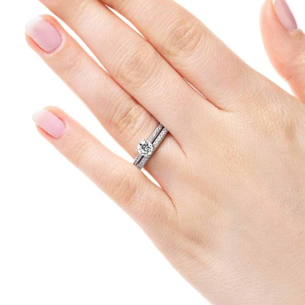 Shown with a 1.0ct Round cut Lab-Grown Diamond with a diamond accented band in recycled 14K white gold with matching wedding band 