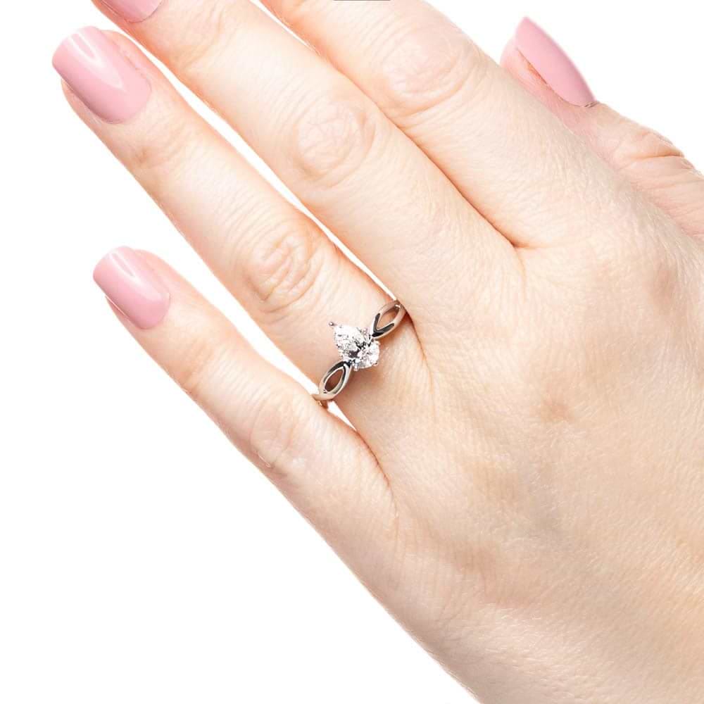 Shown with 1ct Pear Cut Lab Grown Diamond in 16k White Gold|Solitaire engagement ring with a 1ct pear cut lab grown diamond in twisted metal design 16k white gold band shown worn on hand