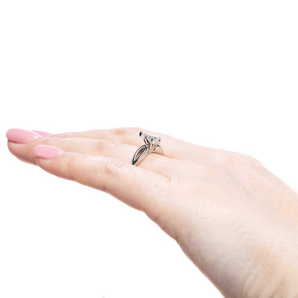 Shown with 1ct Pear Cut Lab Grown Diamond in 16k White Gold|Solitaire engagement ring with a 1ct pear cut lab grown diamond in twisted metal design 16k white gold band shown worn on hand sideview