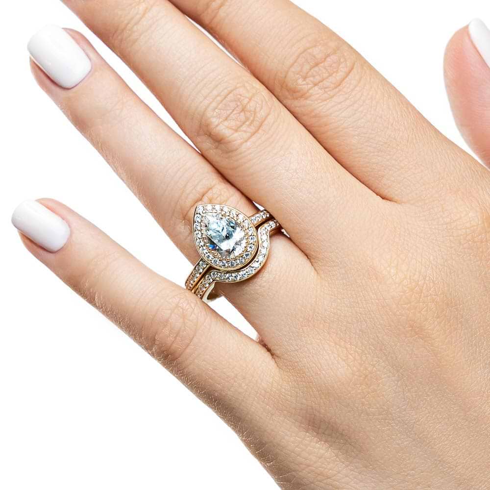 Shown with a 1.0ct Pear cut Lab-Grown Diamond with a diamond accented halo and band in recycled 14K yellow gold with matching wedding band | french engagement ring Shown with a 1.0ct Pear cut Lab-Grown Diamond with a diamond accented halo and band in recycled 14K yellow gold matching wedding band