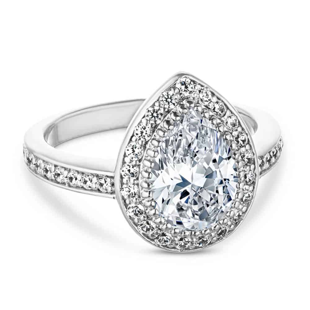 Shown with a 1.0ct Pear cut Lab-Grown Diamond with a diamond accented halo and band in recycled 14K white gold 