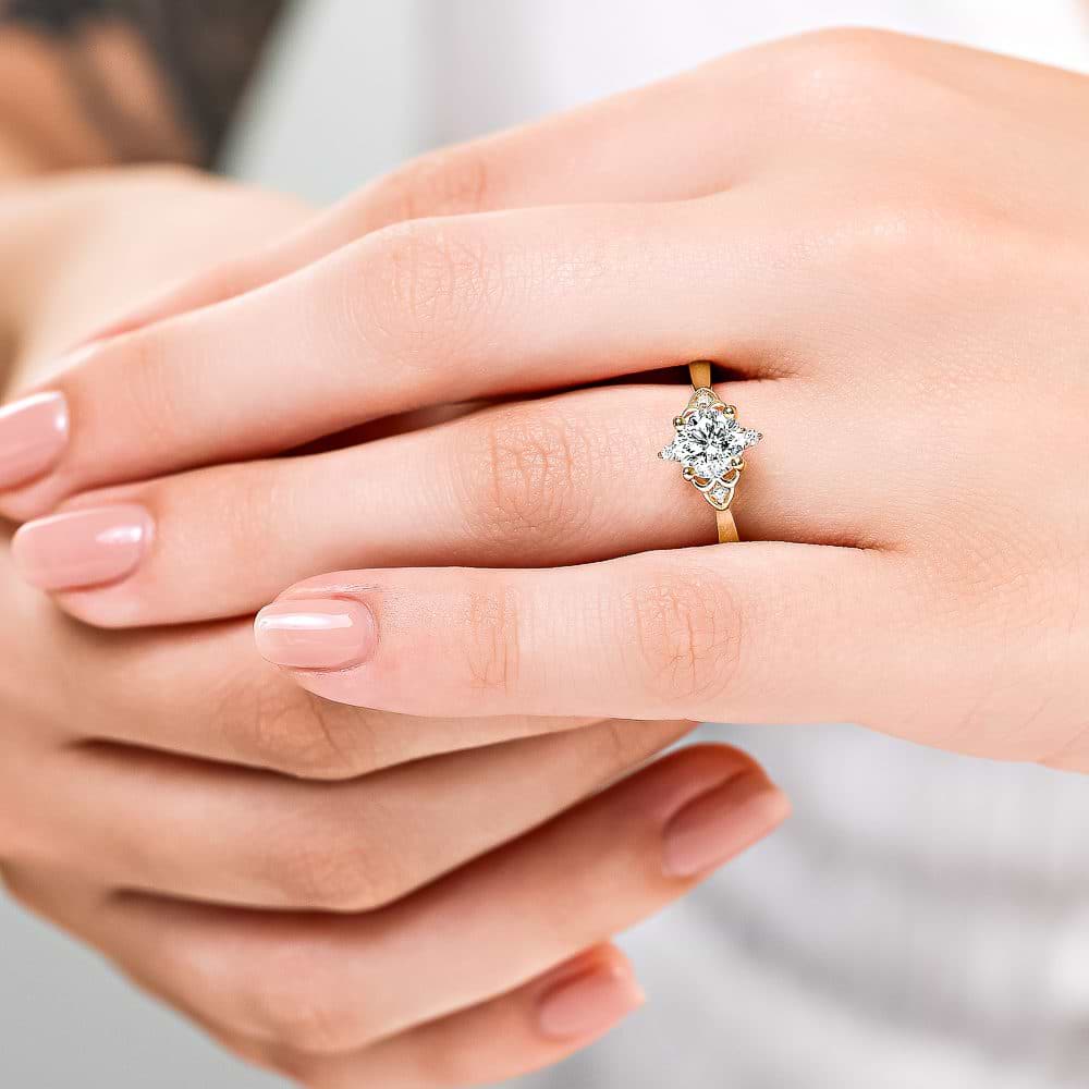 Shown here with a 1.0ct Round Cut Lab Grown Diamond center stone in 14K Yellow Gold|diamond accented engagement ring with round cut lab grown diamond center stone set in 14k yellow gold metal