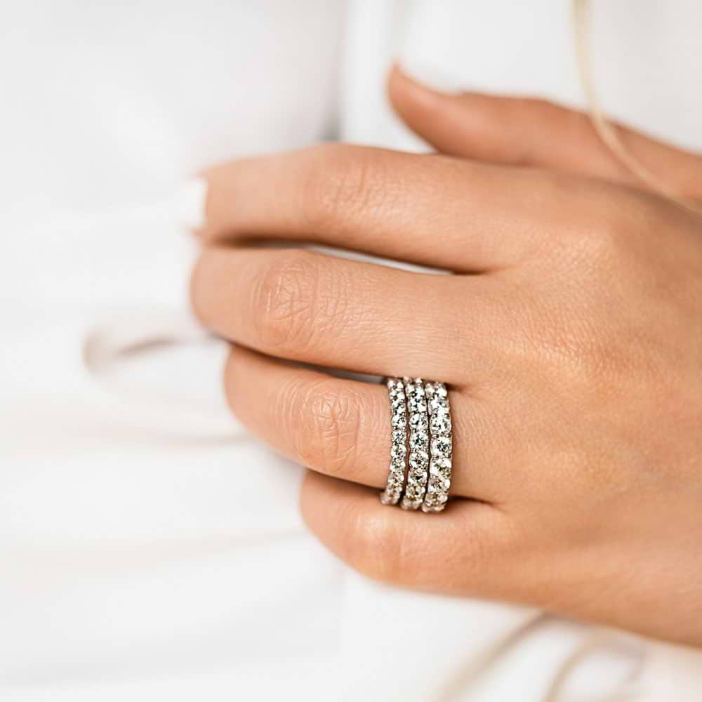 Comparing 0.50ctw, 1ctw and 1.5ctw in 14k White Gold|Three different sized lab grown diamond bands in 14k white gold worn on hand stacked