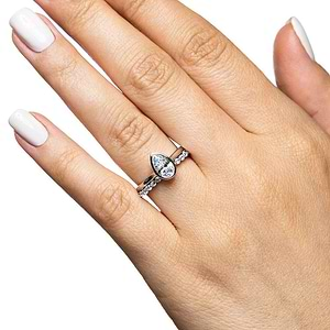  stackable wedding set Shown with a bezel set 1.0ct Pear cut Lab-Grown Diamond in recycled 14K white gold with the matching diamond accented band