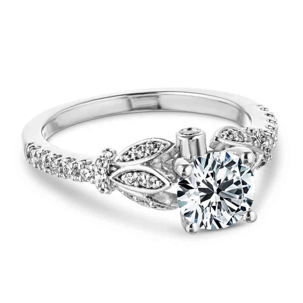 Shown with a 1.0ct Round cut Lab Grown Diamond with leaf details and accented diamonds on the band in recycled 14K white gold