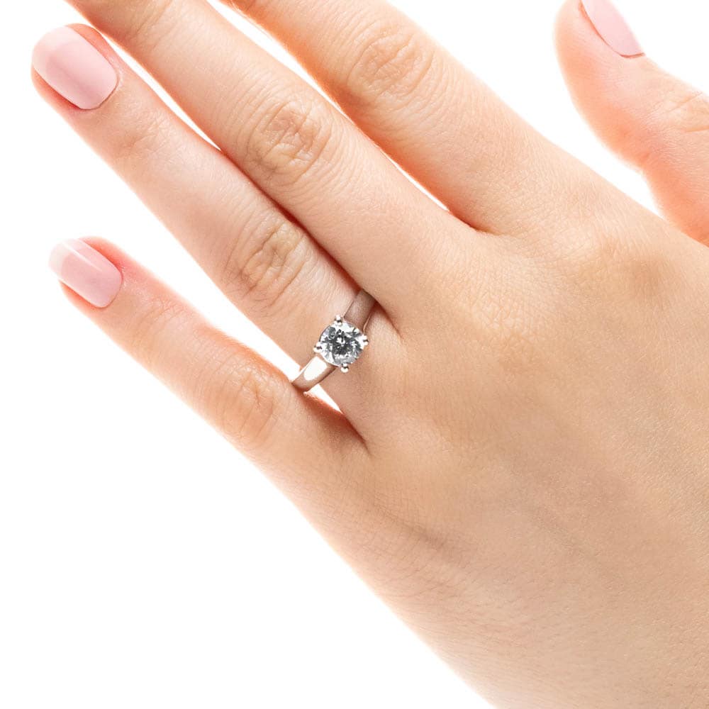 Shown with 1ct Round Cut Lab Grown Diamond in 14k White Gold|Simple trellis style solitaire engagement ring with 1ct round cut lab grown diamond in 14k white gold worn on hand