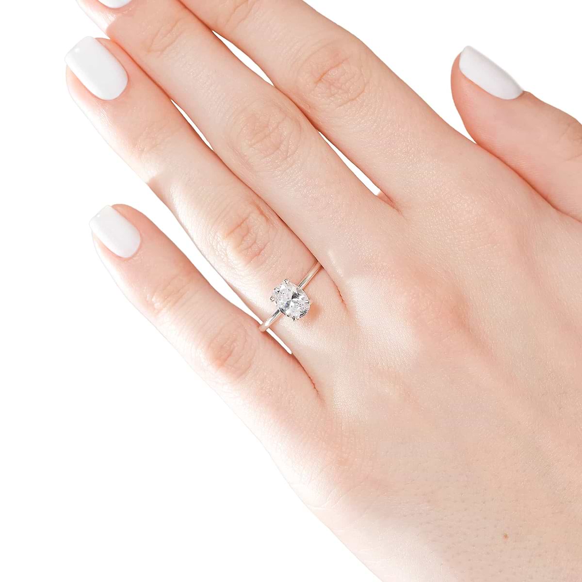 Shown with 1ct Oval Cut Lab Grown Diamond in 14k White Gold|Classic solitaire engagement ring with 1ct oval cut lab grown diamond in 14k white gold band worn on hand
