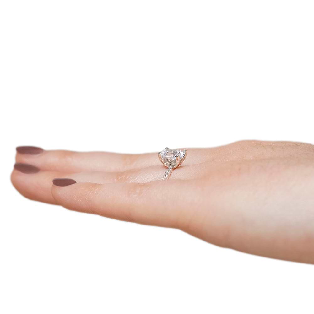Shown with 1.5ct Oval Cut Lab Grown Diamond in 14k White Gold|Diamond accented hidden halo engagement ring with 1.5ct oval cut lab grown diamond in 14k white gold worn on hand sideview