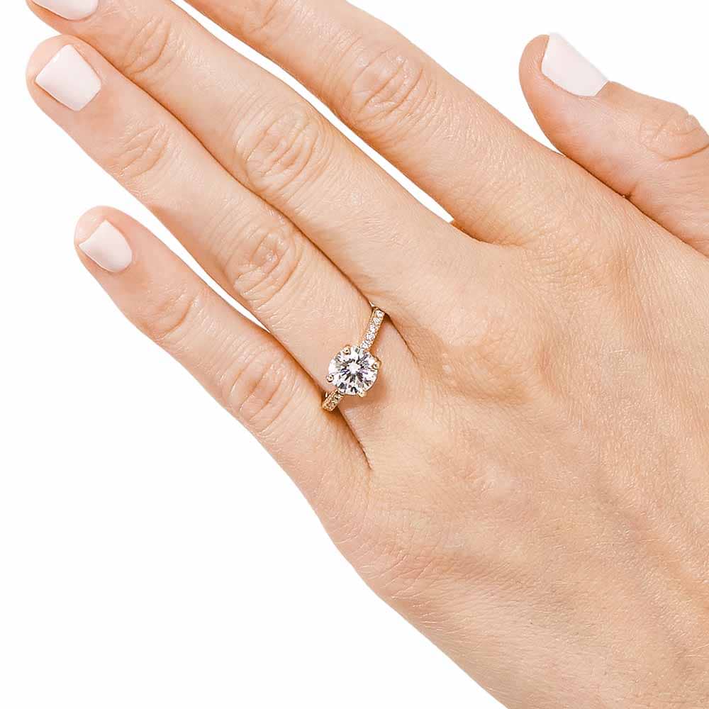 Shown with 1ct Round Cut Lab Grown Diamond in 14k Yellow Gold|Diamond accented solitaire engagement ring with 1ct round cut lab grown diamond in 14k yellow gold worn on hand