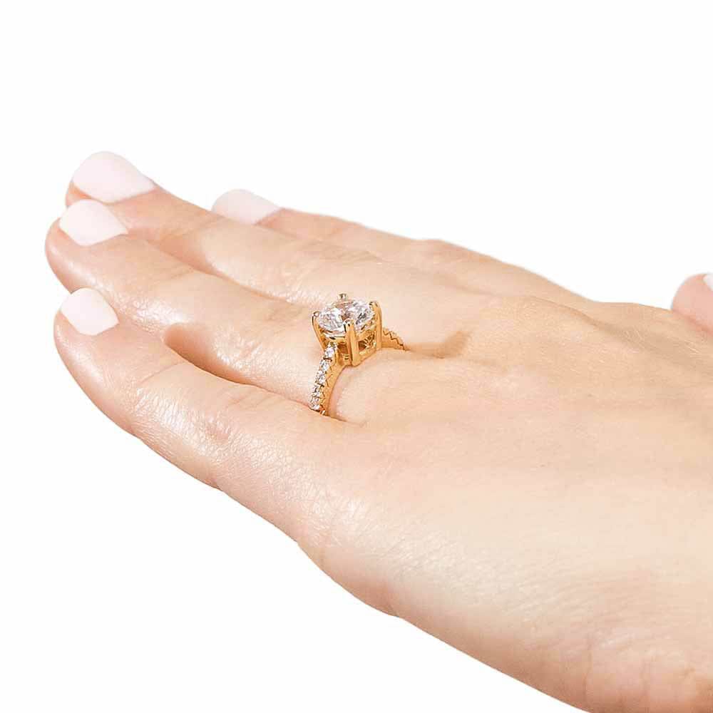 Shown with 1ct Round Cut Lab Grown Diamond in 14k Yellow Gold|Diamond accented solitaire engagement ring with 1ct round cut lab grown diamond in 14k yellow gold worn on hand sideview