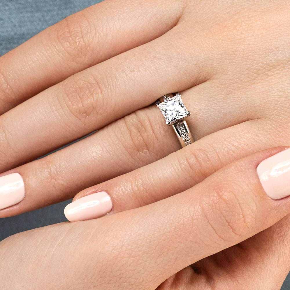 Shown with 1ct Princess Cut Lab Grown Diamond in 14k White Gold|Unique cathedral style engagement ring with 1ct princess cut lab diamond in channel set diamond accented 14k white gold band worn on hand