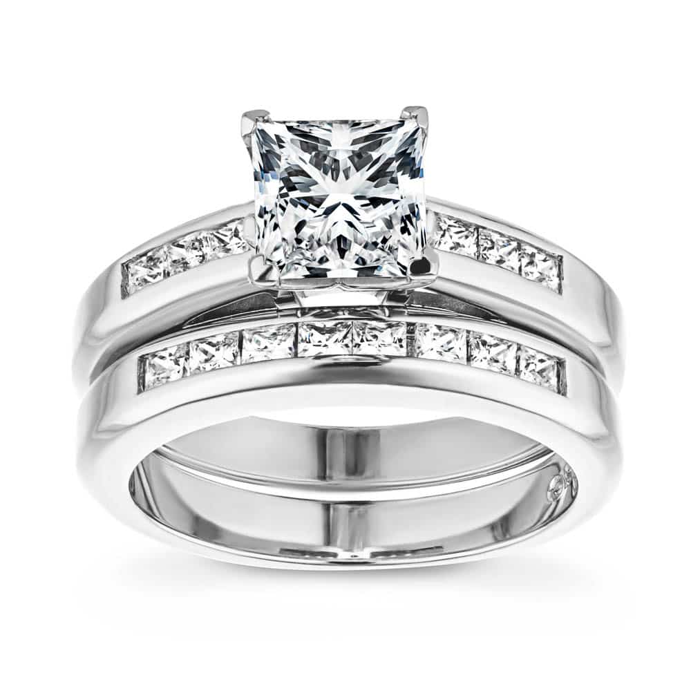 Shown with a 1.0ct Princess cut Lab-Grown Diamond with channel set accenting diamonds in recycled 14K white gold with matching wedding band, can be purchased together for a discounted price 