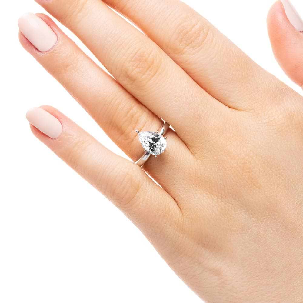 Shown with 1ct Pear Cut Lab Grown Diamond in 14k White Gold|Solitaire engagement ring with 6 prong set 1ct pear cut lab grown diamond in 14k white gold band worn on hand