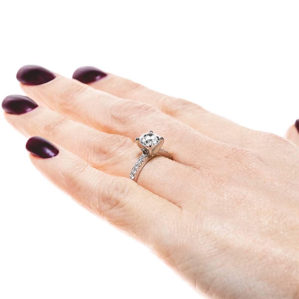 Shown with 1ct Round Cut Lab Grown Diamond in Platinum|Diamond accented engagement ring with 1ct round cut lab grown diamond in platinum setting worn on hand sideview