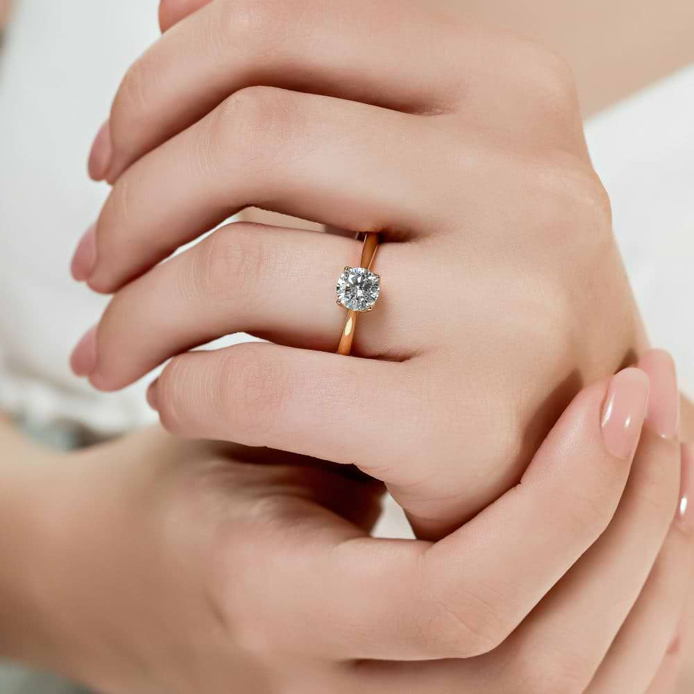 Shown here with a 1.0ct Round Cut Lab Grown Diamond center stone in 14K Yellow Gold|solitaire engagement ring with nature inspired floral prong head with lab grown diamond center stone set in 14k yellow gold metal