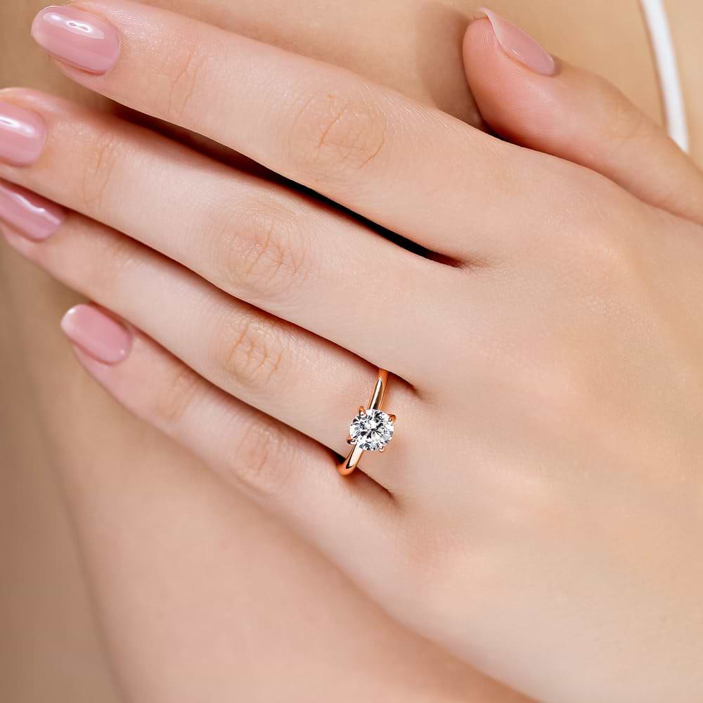 Shown here with a 1.0ct Round Cut Lab Grown Diamond center stone in 14K Rose Gold|shown with 1 carat lab grown diamond center stone with nature inspired floral prong head set in 14k rose gold