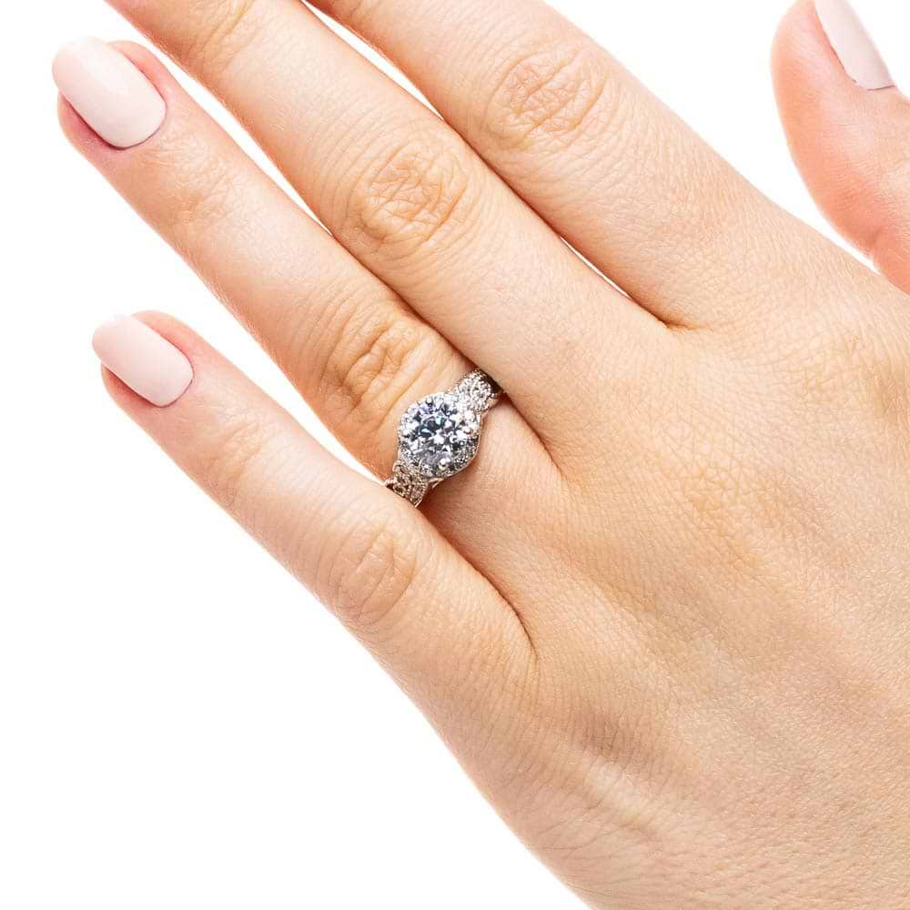 Shown with 1ct Round Cut Lab Grown Diamond in 14k White Gold|Vintage style diamond accented halo engagement ring with 1ct round cut lab created diamond with milgrain and filigree detailing in two tone 14k white gold worn on hand