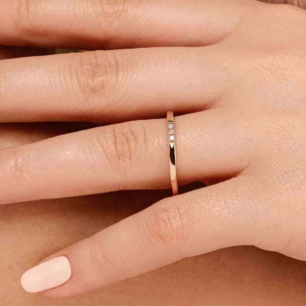 Three Lab-Grown Diamonds set in a simple band in recycled 10K rose gold 