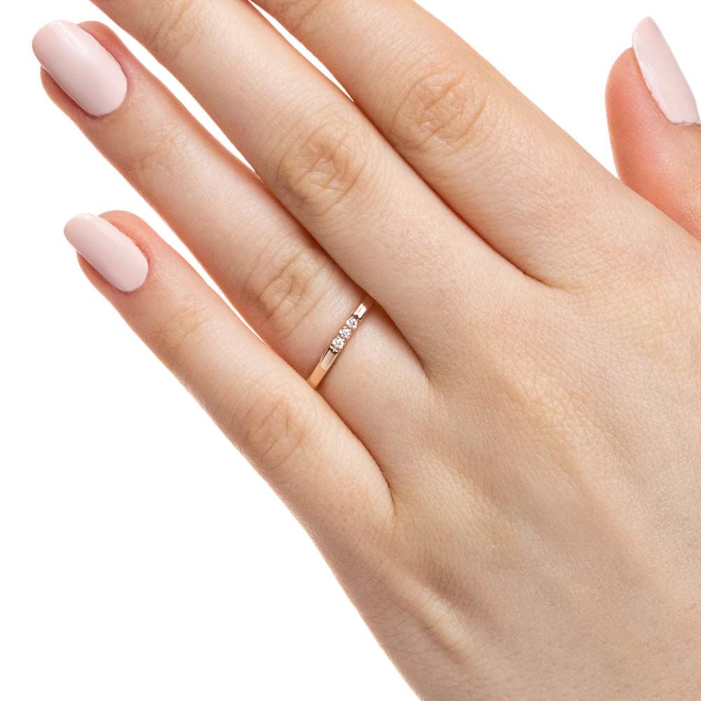 Three Lab-Grown Diamonds set in a simple band in recycled 10K rose gold 