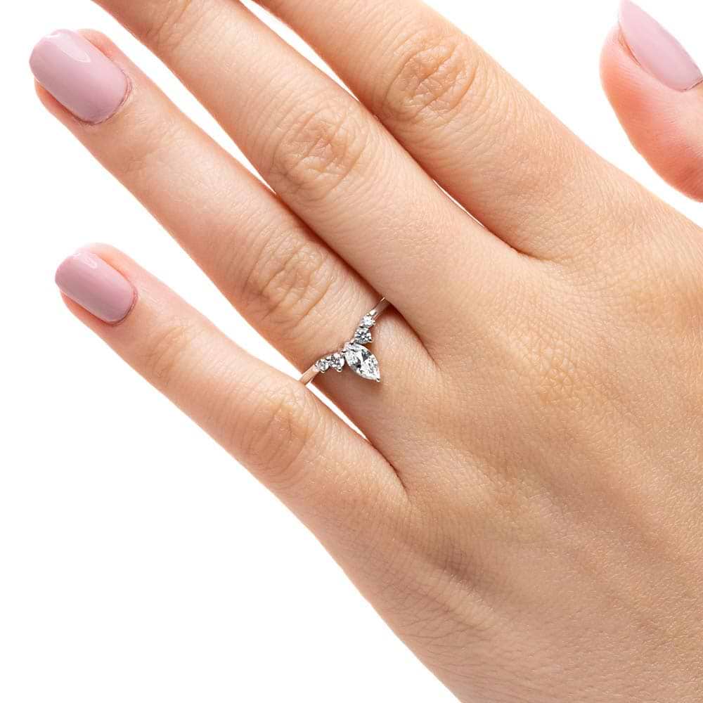 Shown here with a center 0.33ct marquis lab-grown diamond in recycled 14K white gold, with recycled earth-mined diamonds on either side.  | Lab-grown diamond and recycled diamond white gold traditional engagement ring.