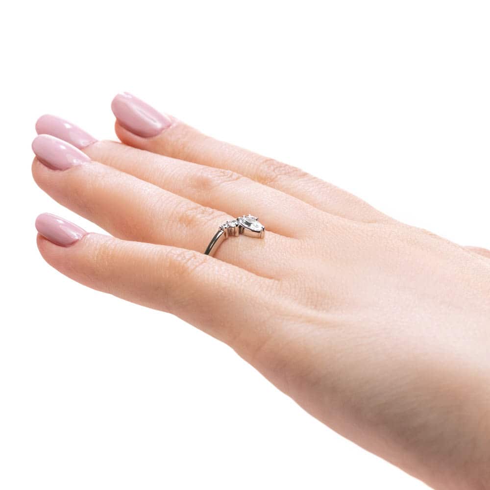 Shown here with a center 0.33ct marquis lab-grown diamond in recycled 14K white gold, with recycled earth-mined diamonds on either side.  | Lab-grown diamond and recycled diamond white gold traditional engagement ring.