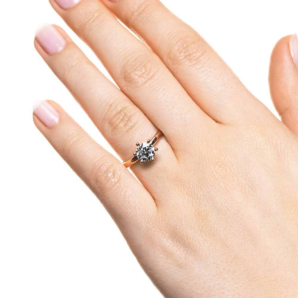 Shown here with a 1.5ct Round lab-grown diamond in a six prong rose gold setting. | Lab-grown diamond rose gold four prong solitaire engagement ring.