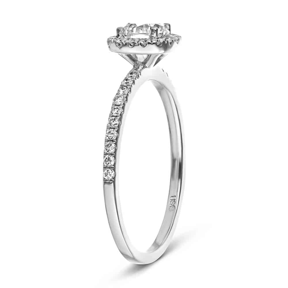 Shown with a 1.0ct Round cut Lab-Grown Diamond with a diamond accented halo and accented band in recycled 14K white gold 