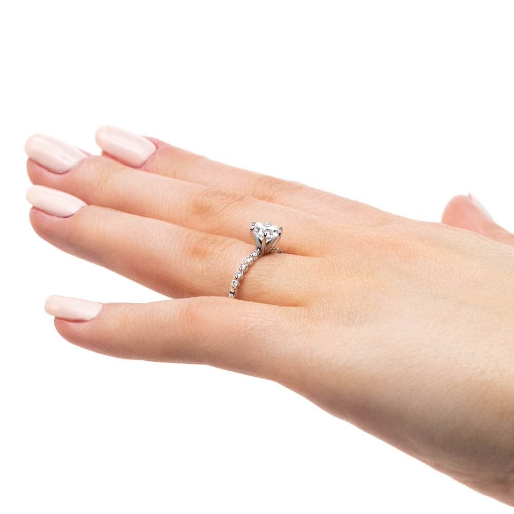 Shown with a 1.0ct Round cut Lab-Grown Diamond with accenting diamonds on the band in recycled 14K white gold 