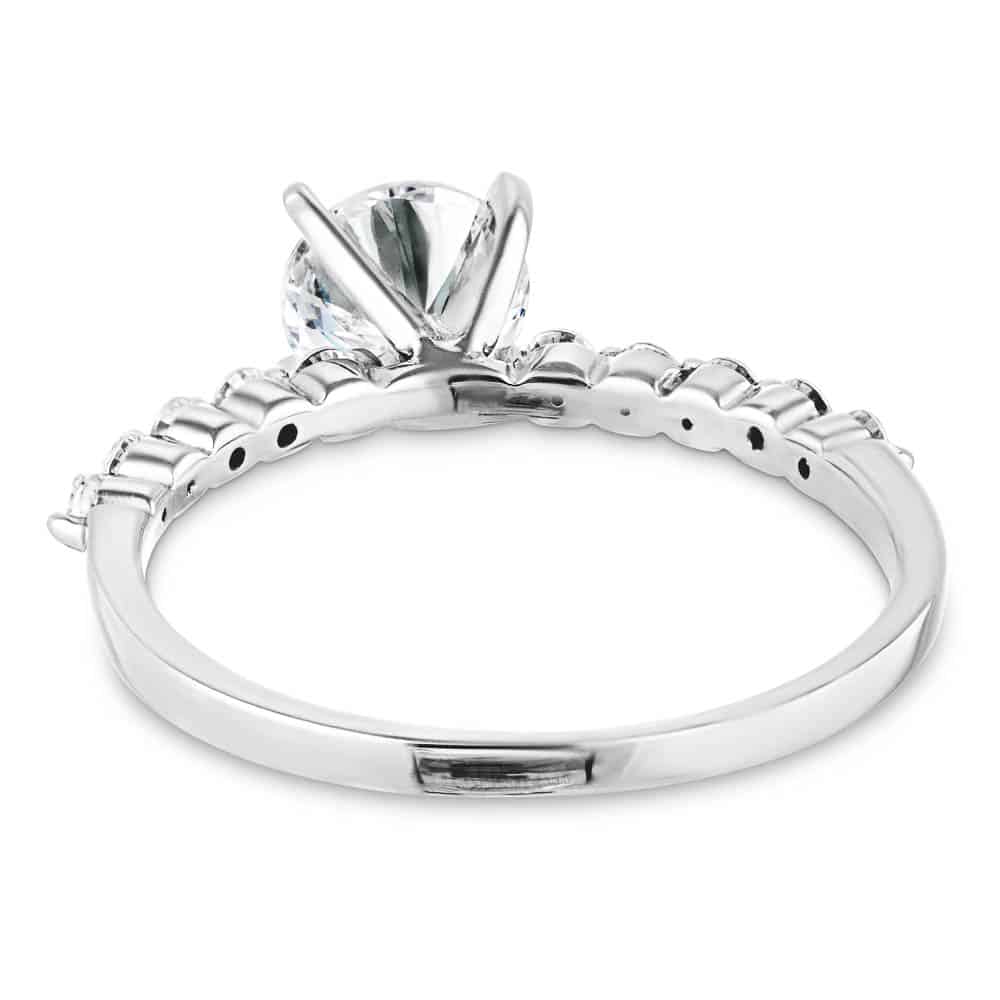 Shown with a 1.0ct Round cut Lab-Grown Diamond with accenting diamonds on the band in recycled 14K white gold 