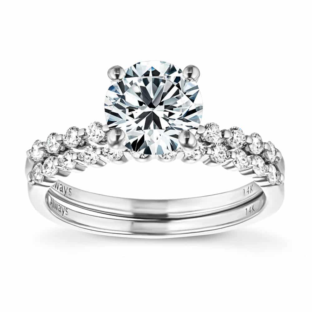 Shown with a 1.0ct Round cut Lab-Grown Diamond with accenting diamonds on the band in recycled 14K white gold with matching wedding band, can be purchased together for a discounted price 