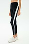 A person wears SPLITS59 Emerson Airweight High Waist leggings in Black/Ice, featuring white and light blue side stripes, paired with white sneakers—ideal for hot yoga or Pilates—posed against a plain background.