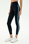 A person models the SPLITS59 Ella High Waist Airweight 7/8 leggings in Black/Stone Blue—ideal for hot yoga—with white athletic shoes, standing against a plain background.