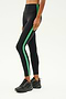 A person wearing the SPLITS59 Clare High Waist Rigor 7/8 in Black/Grass and black sneakers stands against a plain background, highlighting the style and comfort of the high-performance Rigor fabric.