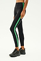 A person wearing the SPLITS59 Clare High Waist Rigor 7/8 in Black/Grass and black sneakers stands against a plain background, highlighting the style and comfort of the high-performance Rigor fabric.