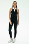 A person stands against a plain background wearing the SPLITS59 Amber Airweight High Waist 7/8 leggings in Black/White.