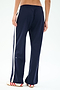 Person wearing SPLITS59 Maxie Rigor Track Pant - Indigo/White with white side stripes and sneakers, shown from the back against a plain light background. Wide leg pants crafted from durable Rigor fabric for all-day comfort.