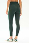Model wears SPLITS59 Amber Airweight High Waist 7/8 leggings in Military/Spearmint, featuring a soft nylon-spandex blend and green side stripe, paired with white sneakers with green stripes. Shown from the back against a plain background.