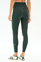 Model wears SPLITS59 Amber Airweight High Waist 7/8 leggings in Military/Spearmint, featuring a soft nylon-spandex blend and green side stripe, paired with white sneakers with green stripes. Shown from the back against a plain background.